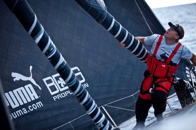 Casey Smith caddies a sail on the foredeck as it goes up the rig. PUMA Ocean Racing powered by BERG during Leg 1 of the Volvo Ocean Race 2011-12 © Amory Ross/Puma Ocean Racing/Volvo Ocean Race http://www.puma.com/sailing